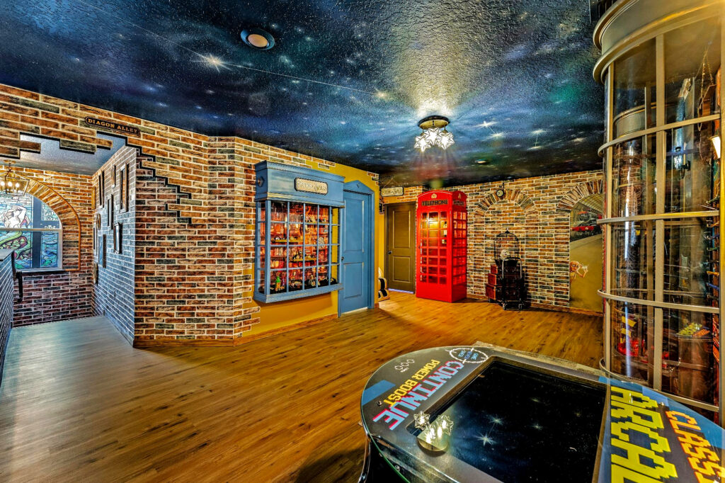 Harry Potter Diagon Alley themed loft game room and lounge with built in custom escape game in Orlando airbnb vacation rental designed by Magic Interiors